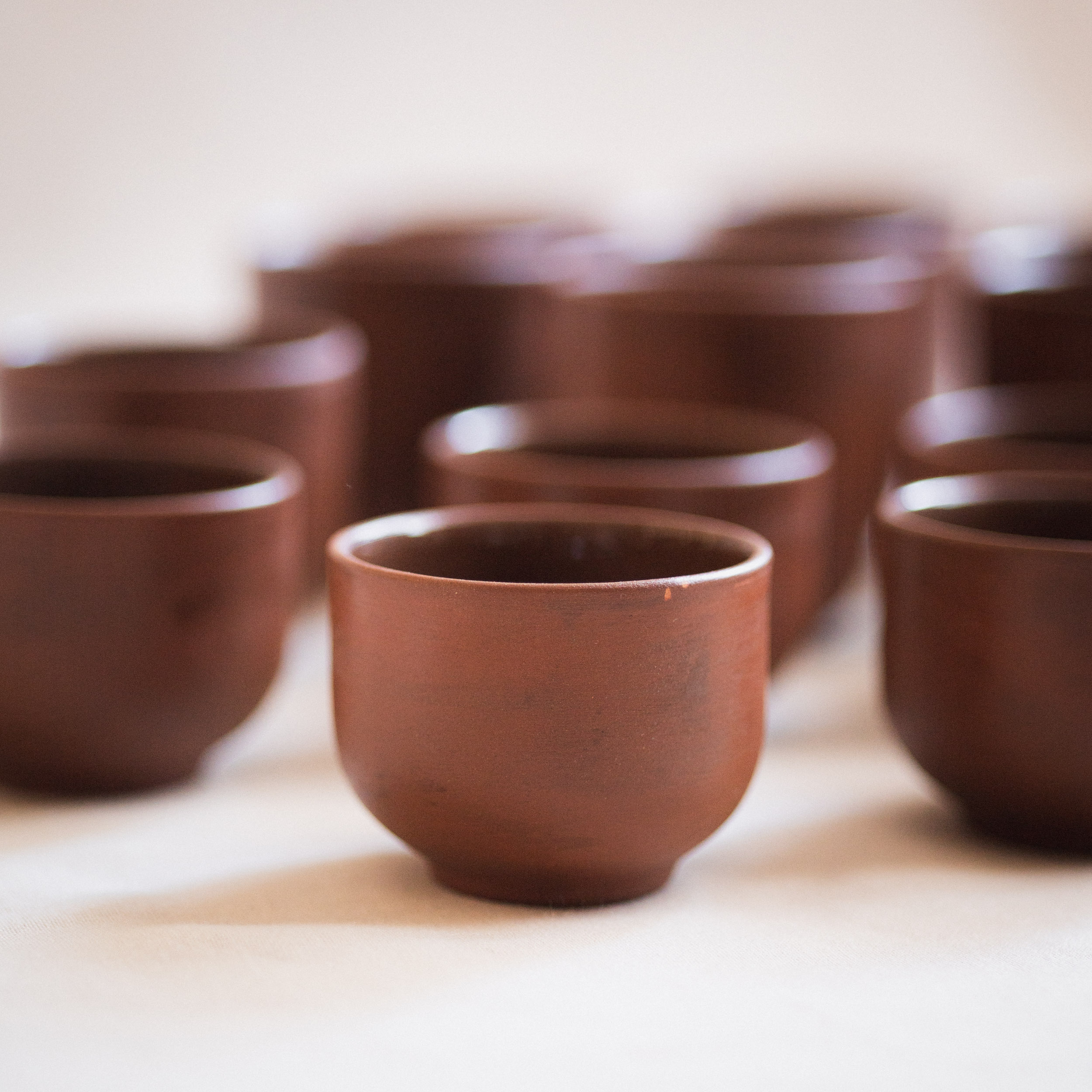 handmade ceramic coffee or tea cup in brown clay